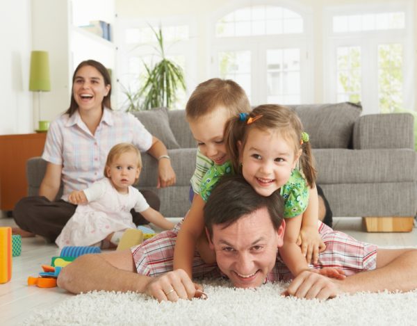 COMFORT family playing in living room shutterstock  e
